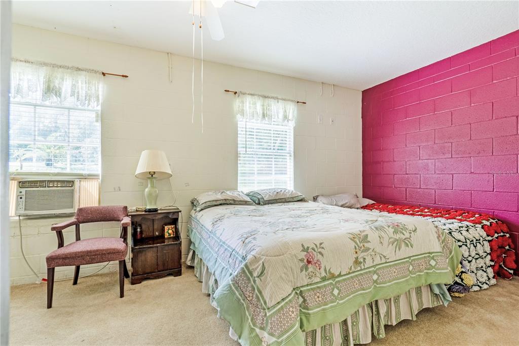 2060 Doyle Road Deltona, FL 32738 - Photo 18 of 43 a bedroom with a bed and a chandelier