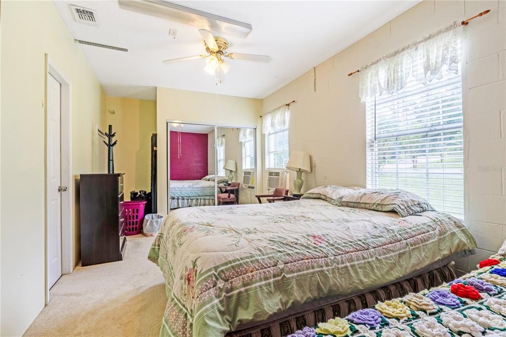 2060 Doyle Road Deltona, FL 32738 - Photo 19 of 43 a bedroom with a bed and a chandelier