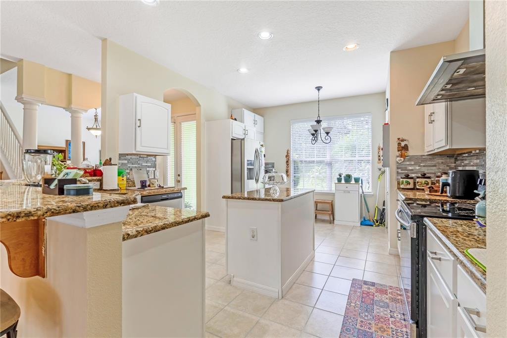 2060 Doyle Road Deltona, FL 32738 - Photo 26 of 43 a kitchen with stainless steel appliances granite countertop a sink and cabinets