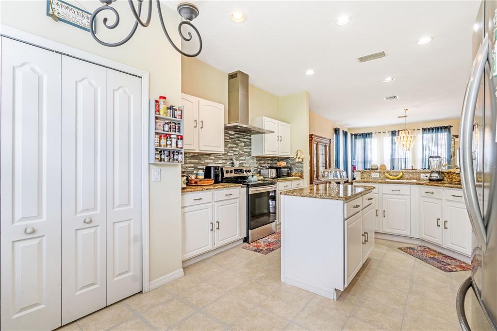 2060 Doyle Road Deltona, FL 32738 - Photo 27 of 43 a kitchen with white cabinets and white appliances