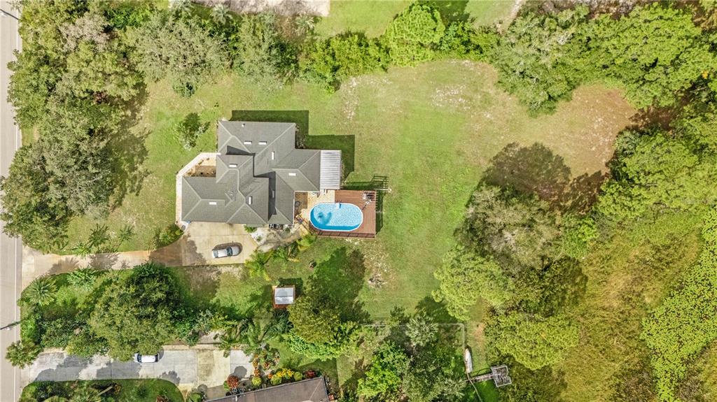 2060 Doyle Road Deltona, FL 32738 - Photo 3 of 43 an aerial view of residential house with outdoor space and trees all around