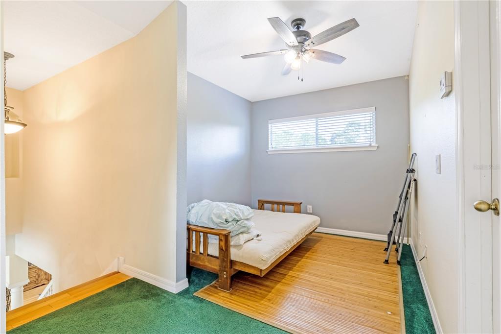 2060 Doyle Road Deltona, FL 32738 - Photo 33 of 43 a bedroom with a bed and a chandelier