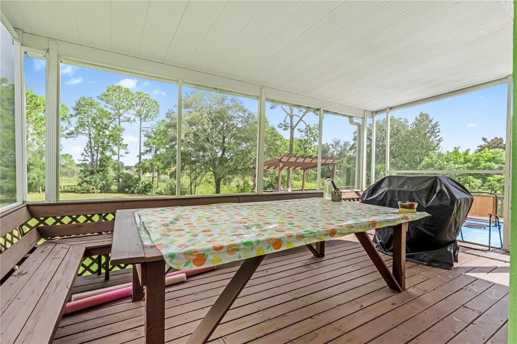 2060 Doyle Road Deltona, FL 32738 - Photo 36 of 43 a view of a balcony with chairs and wooden floor