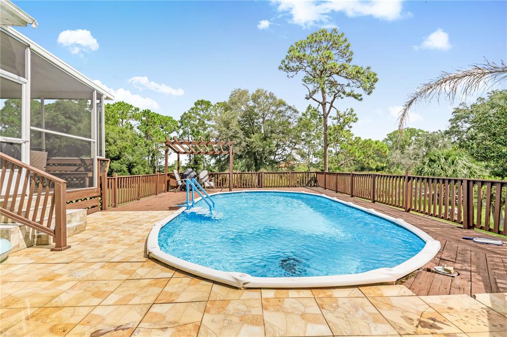 2060 Doyle Road Deltona, FL 32738 - Photo 38 of 43 a view of a swimming pools under an umbrella