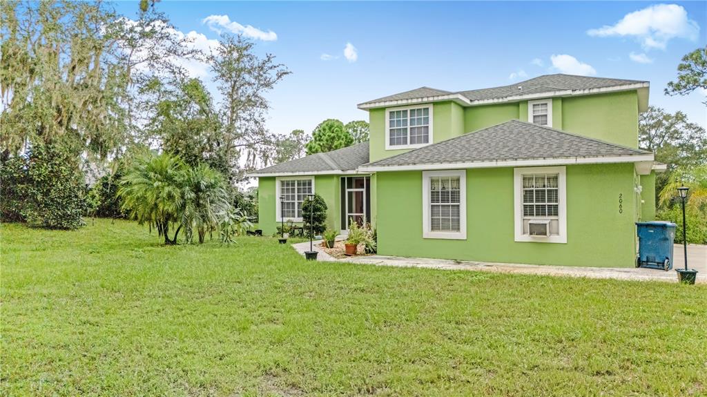 2060 Doyle Road Deltona, FL 32738 - Photo 4 of 43 a front view of a house with a yard