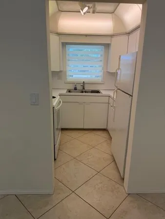 a view of a room with an empty space and a window