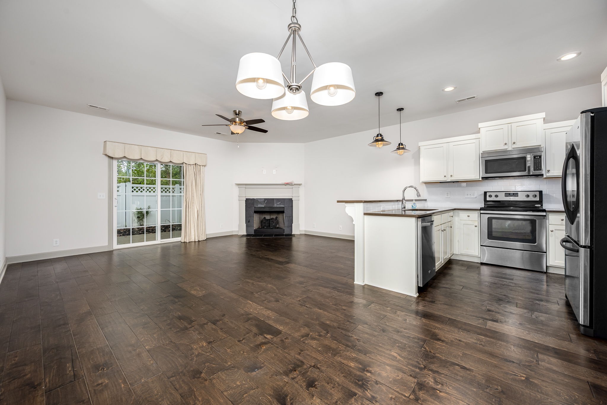 2342 North Tennessee Boulevard, Unit 1503 Murfreesboro, TN 37130 - Photo 11 of 36 a large kitchen with cabinets wooden floor and stainless steel appliances