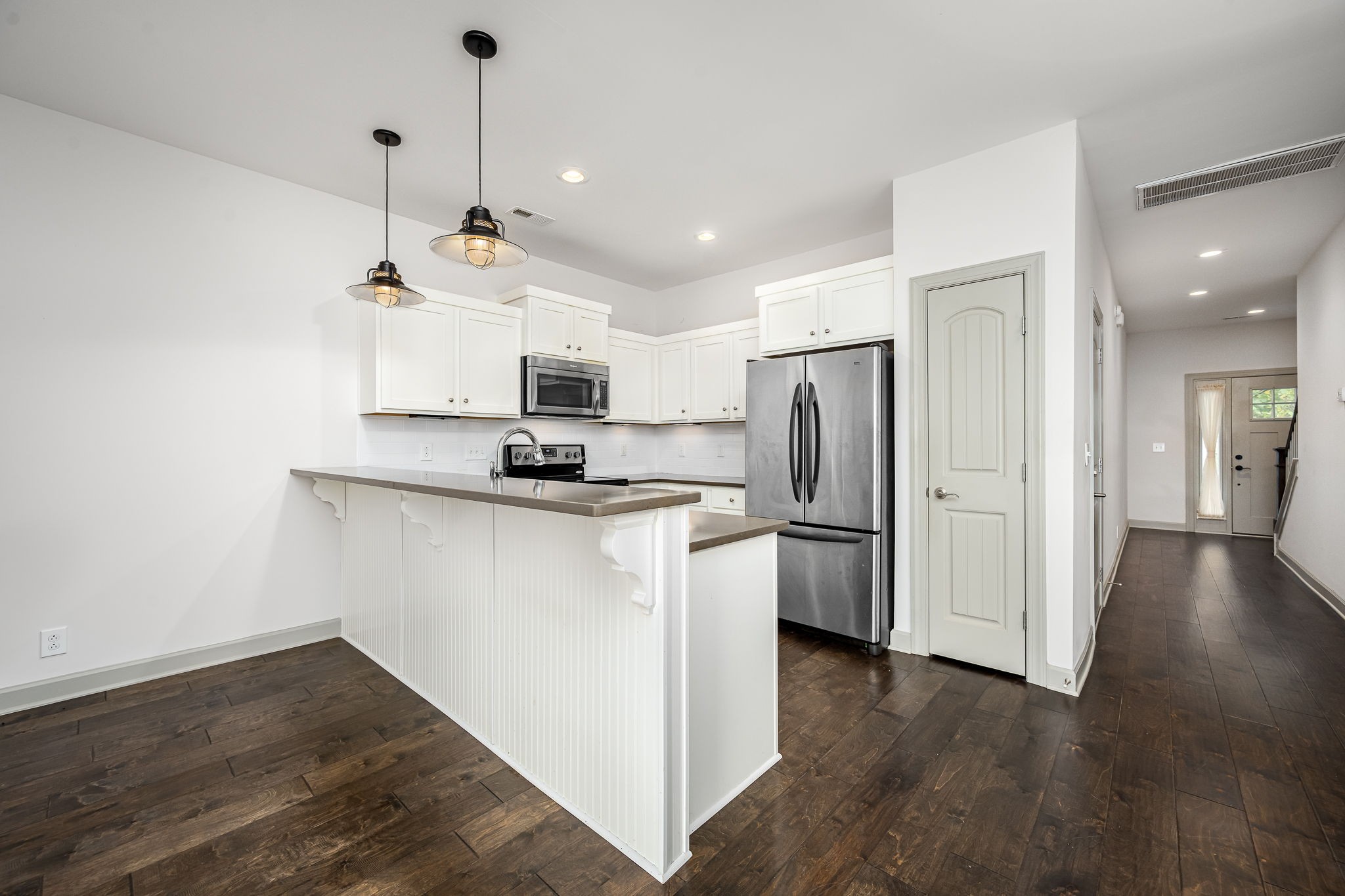 2342 North Tennessee Boulevard, Unit 1503 Murfreesboro, TN 37130 - Photo 15 of 36 a kitchen with kitchen island white cabinets and stainless steel appliances
