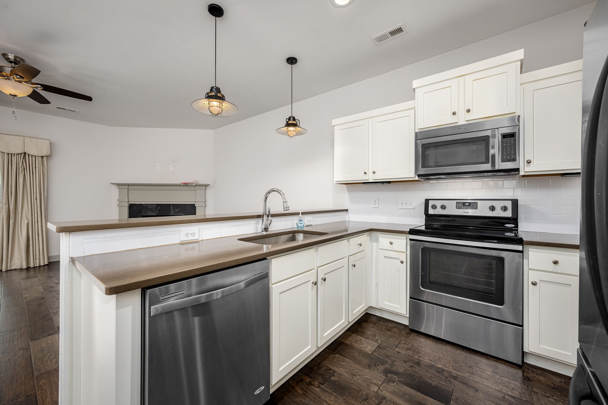 2342 North Tennessee Boulevard, Unit 1503 Murfreesboro, TN 37130 - Photo 17 of 36 a kitchen with granite countertop a sink a stove and microwave