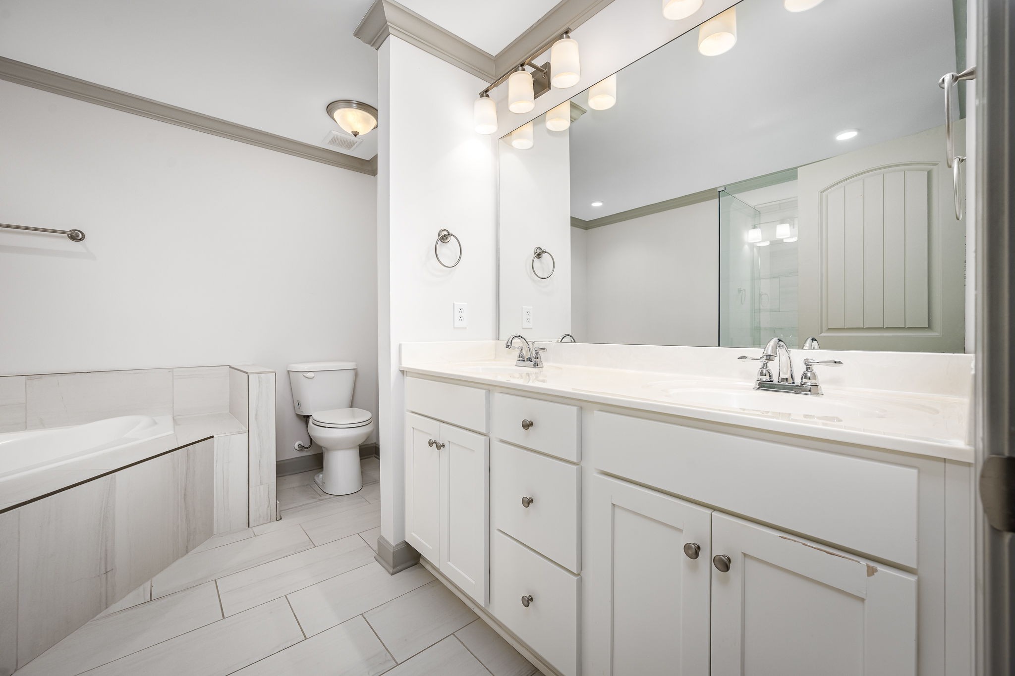 2342 North Tennessee Boulevard, Unit 1503 Murfreesboro, TN 37130 - Photo 25 of 36 a spacious bathroom with a double vanity sink a mirror and a toilet
