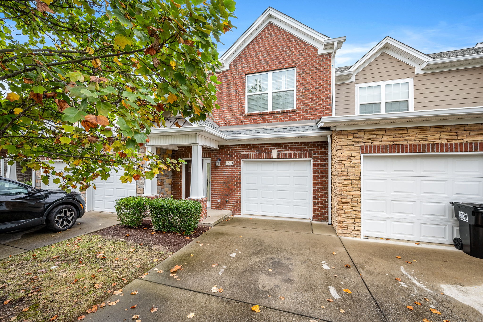 2342 North Tennessee Boulevard, Unit 1503 Murfreesboro, TN 37130 - Photo 3 of 36 a front view of a house with a yard and garage