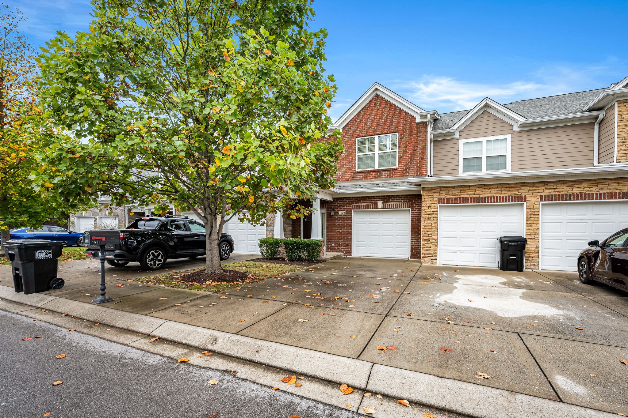 2342 North Tennessee Boulevard, Unit 1503 Murfreesboro, TN 37130 - Photo 4 of 36 a view of a white house with large windows and a large tree
