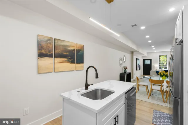 a kitchen with a sink and a refrigerator