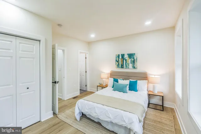 a bedroom with a bed and wooden floor