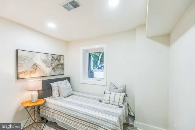 a bedroom with a bed and a painting on the wall