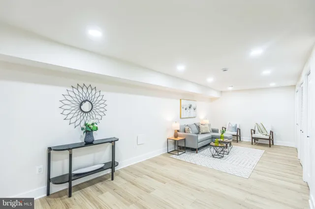 a bedroom with a bed table and a potted plant