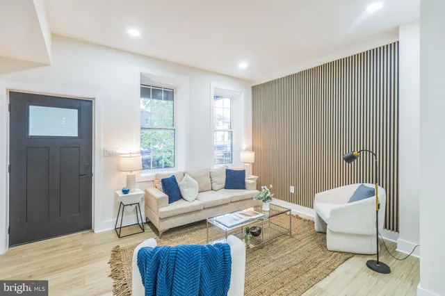 a living room with furniture and a potted plant
