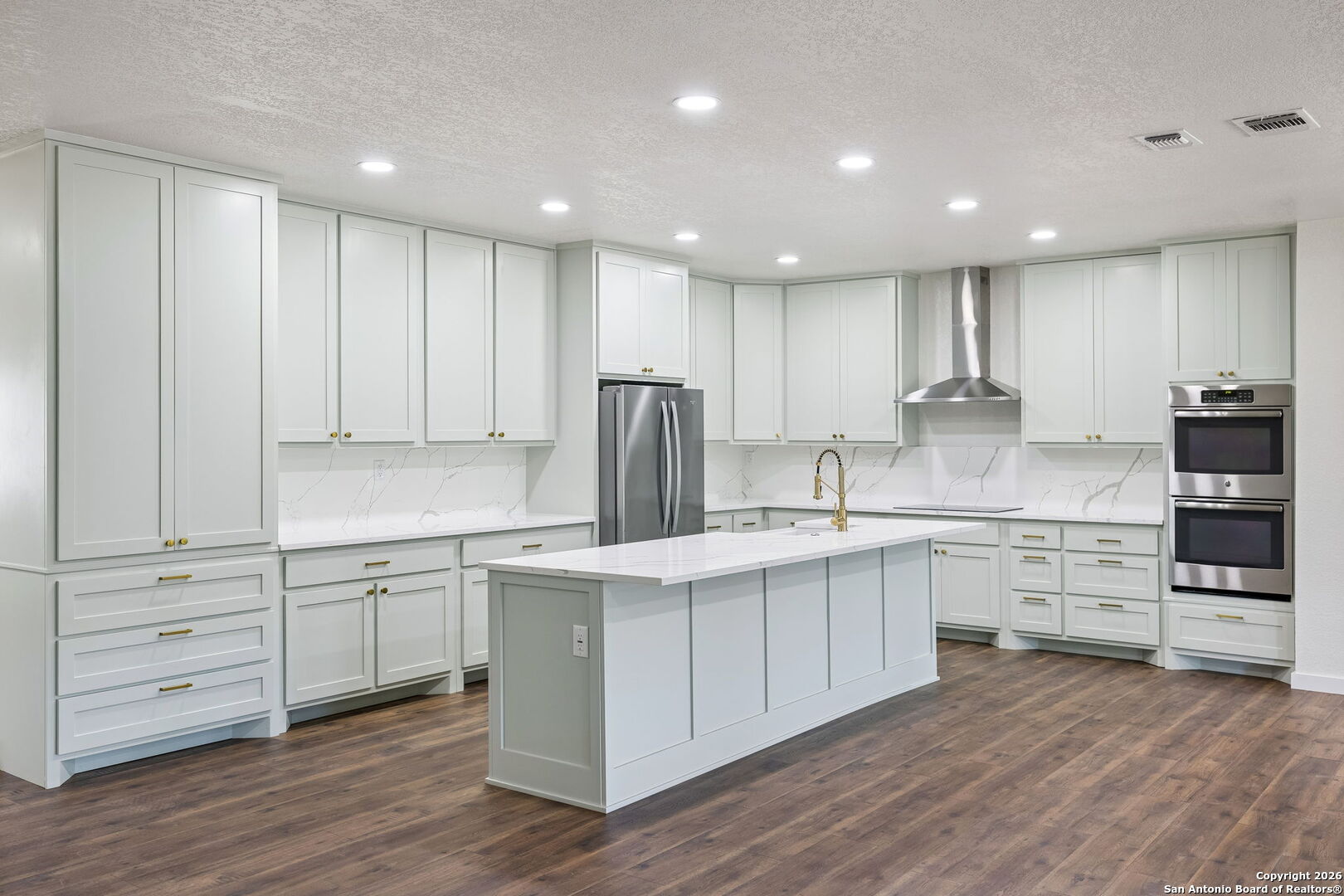 11890 Ranch Road 965 Fredericksburg, TX 78624 - Photo 15 of 40 a kitchen with white cabinets stainless steel appliances and kitchen island