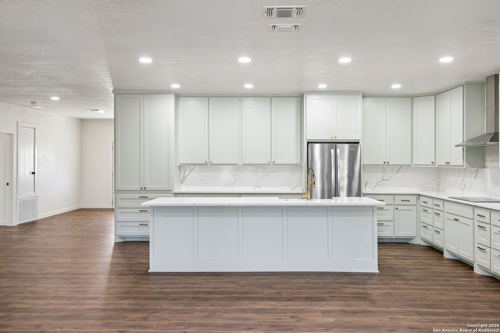 11890 Ranch Road 965 Fredericksburg, TX 78624 - Photo 16 of 40 a large kitchen with granite countertop a stove top oven a sink a counter space and cabinets