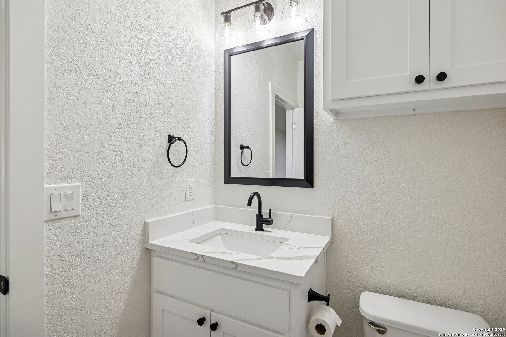11890 Ranch Road 965 Fredericksburg, TX 78624 - Photo 24 of 40 a bathroom with a toilet sink and mirror