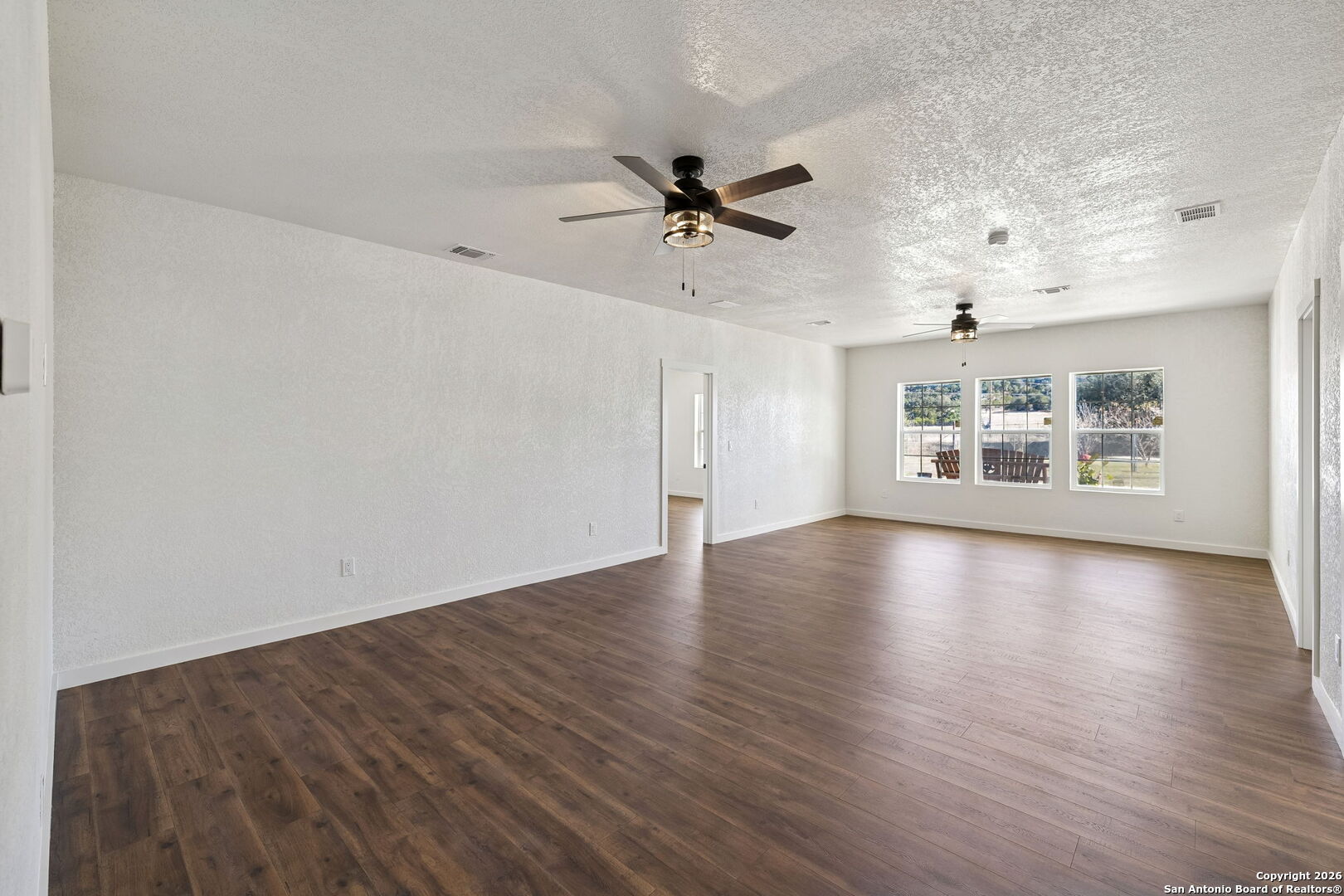 11890 Ranch Road 965 Fredericksburg, TX 78624 - Photo 25 of 40 wooden floor in an empty room with a window