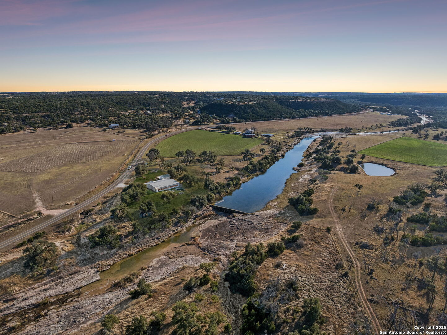 11890 Ranch Road 965 Fredericksburg, TX 78624 - Photo 3 of 40 a view of a lake with mountains in the background