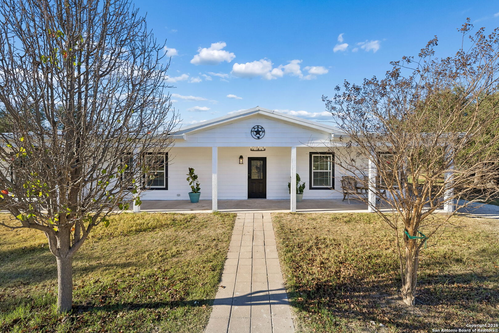 11890 Ranch Road 965 Fredericksburg, TX 78624 - Photo 8 of 40 a front view of a house with a yard
