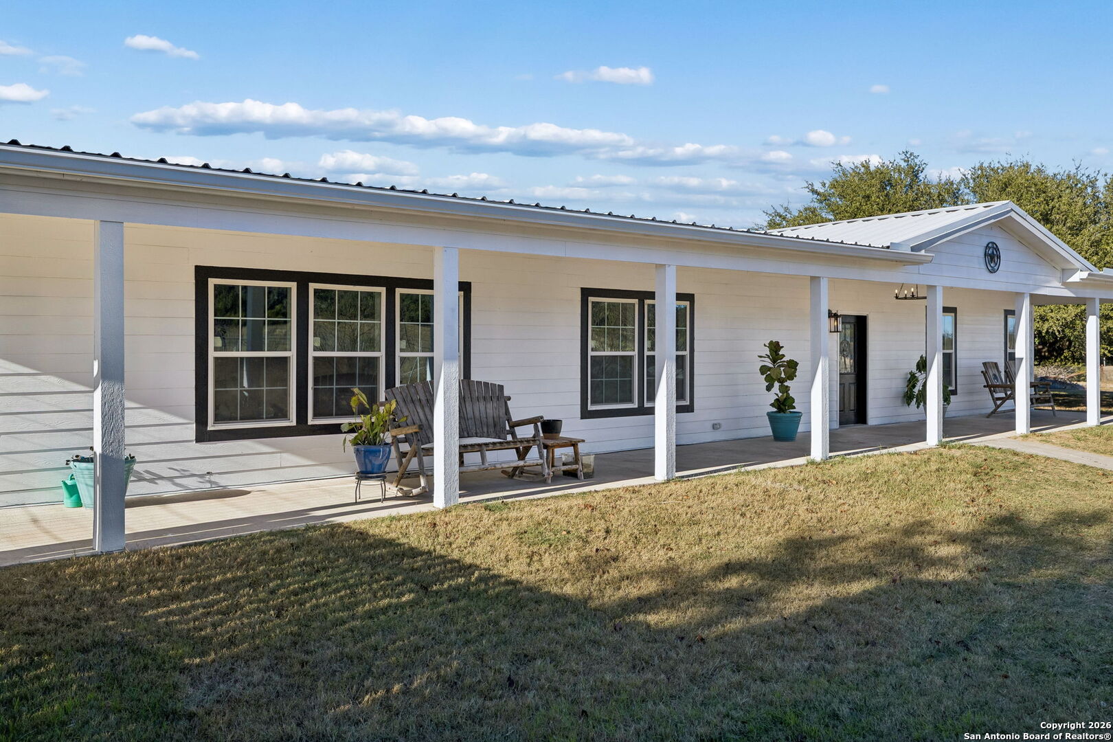 11890 Ranch Road 965 Fredericksburg, TX 78624 - Photo 10 of 40 a front view of a house with sitting area and garden