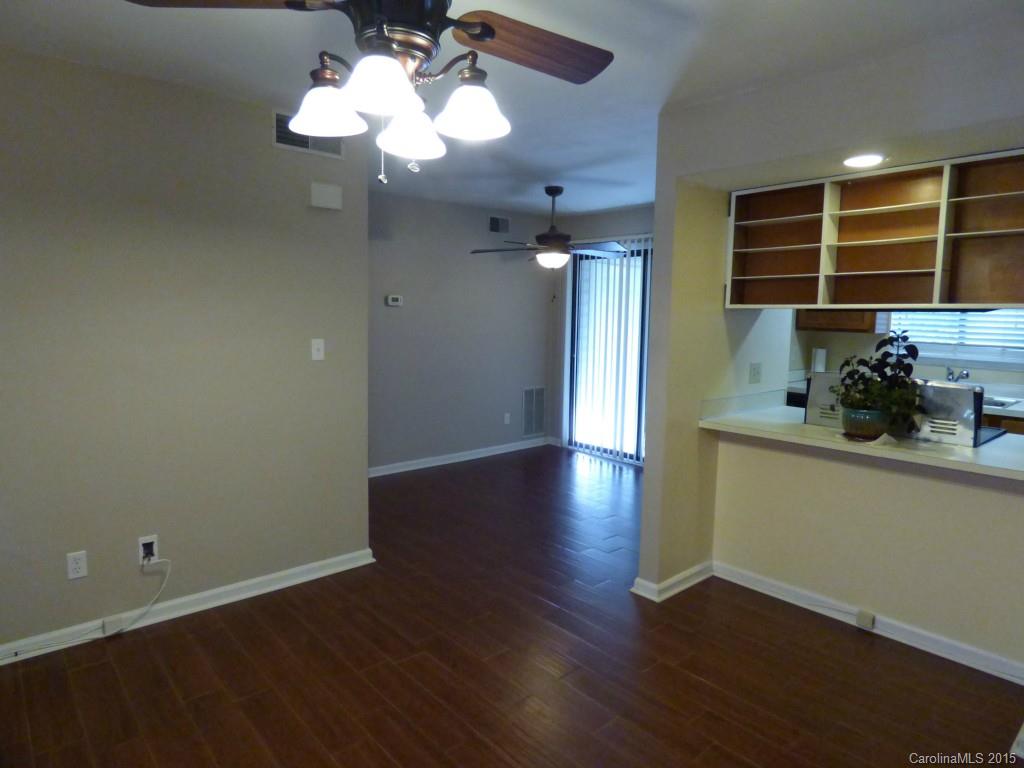 11030 Running Ridge Road, Unit 8435 Charlotte, NC 28226 - Photo 2 of 18 a view of a room with wooden floor and chandelier fan