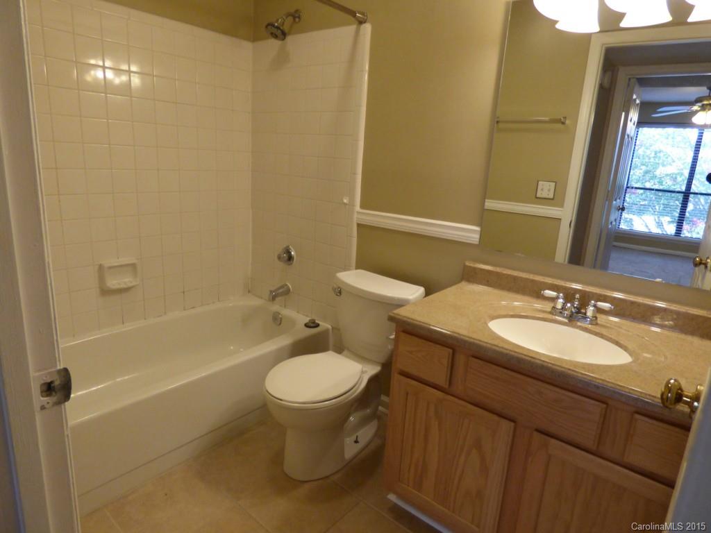 11030 Running Ridge Road, Unit 8435 Charlotte, NC 28226 - Photo 15 of 18 a bathroom with a sink toilet and shower
