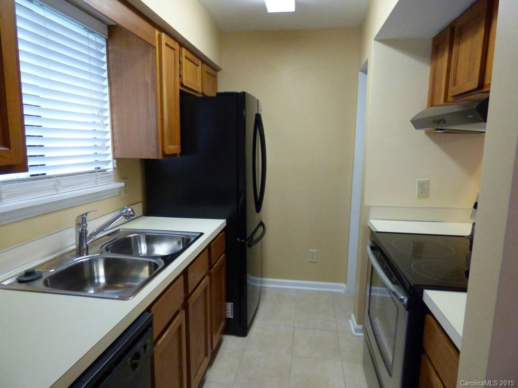 11030 Running Ridge Road, Unit 8435 Charlotte, NC 28226 - Photo 5 of 18 a kitchen with a sink and refrigerator