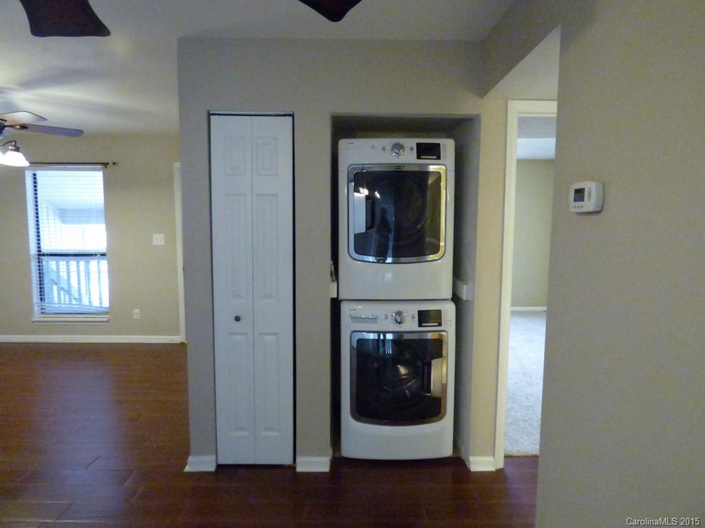 11030 Running Ridge Road, Unit 8435 Charlotte, NC 28226 - Photo 8 of 18 a view of a hallway with wooden floor and closet