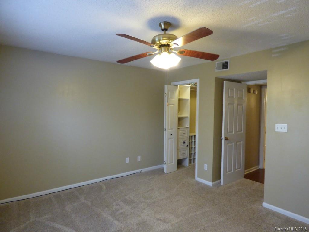 11030 Running Ridge Road, Unit 8435 Charlotte, NC 28226 - Photo 10 of 18 an empty room with closet and a chandelier fan