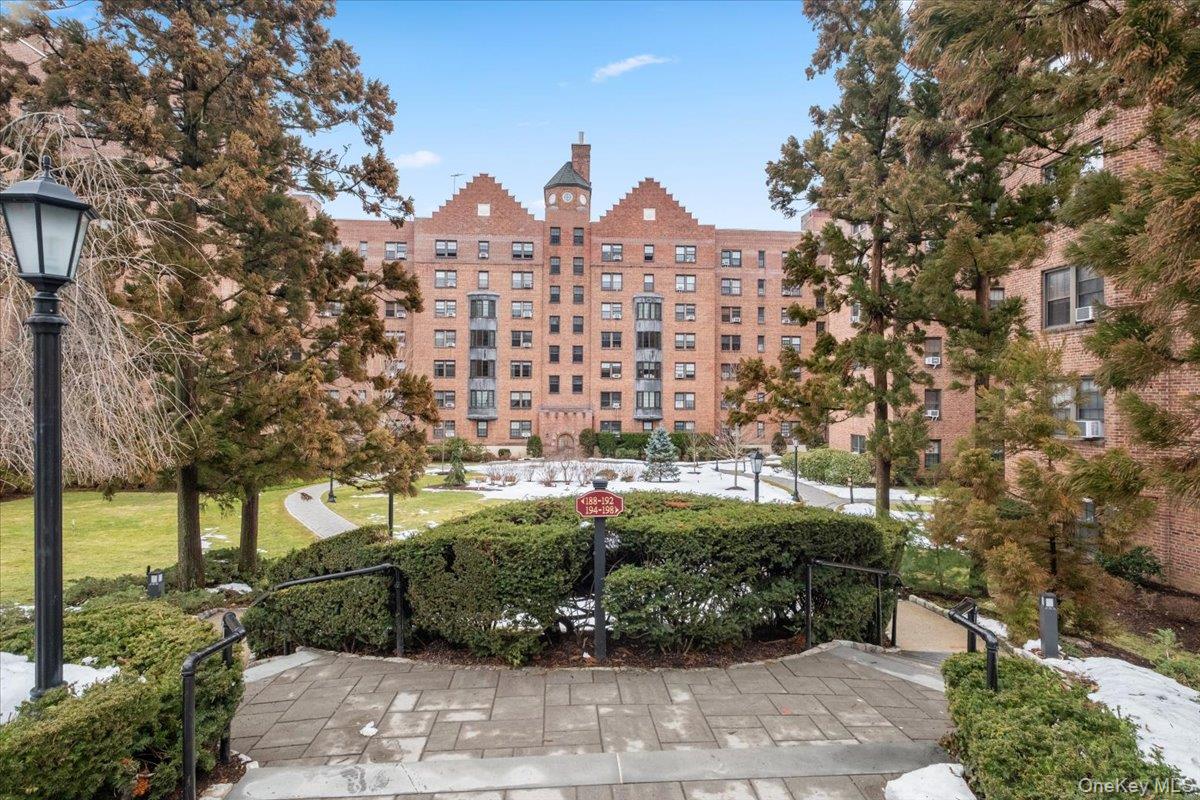 a front view of a house with a yard and a garden