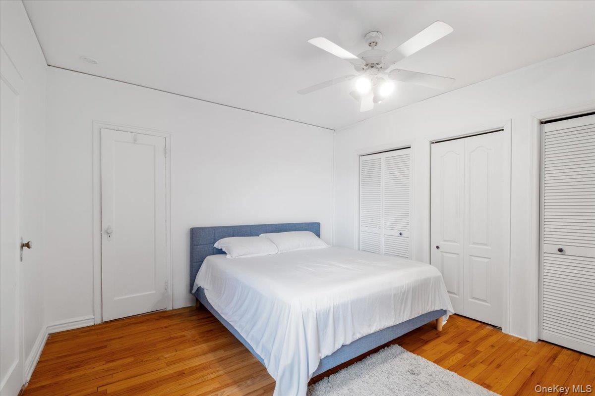 190 Garth Road, Unit 3R Scarsdale, NY 10583 - Photo 16 of 31 a bedroom with a bed and a ceiling fan