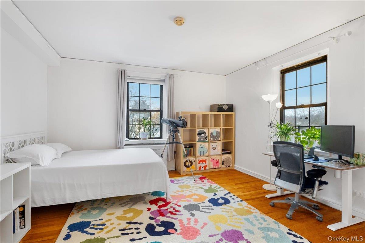 190 Garth Road, Unit 3R Scarsdale, NY 10583 - Photo 17 of 31 a bedroom with a bed and a bookshelf