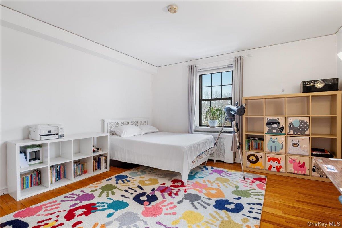 190 Garth Road, Unit 3R Scarsdale, NY 10583 - Photo 19 of 31 a bed room with a bed and a book shelf