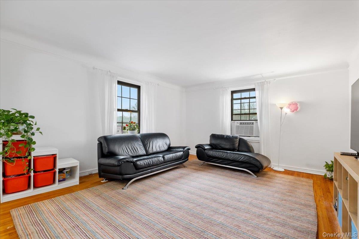190 Garth Road, Unit 3R Scarsdale, NY 10583 - Photo 5 of 31 a living room with furniture and a wooden floor
