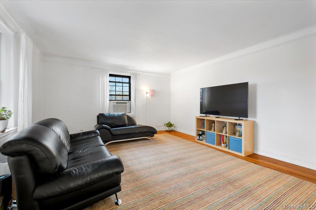 190 Garth Road, Unit 3R Scarsdale, NY 10583 - Photo 6 of 31 a living room with furniture and a flat screen tv