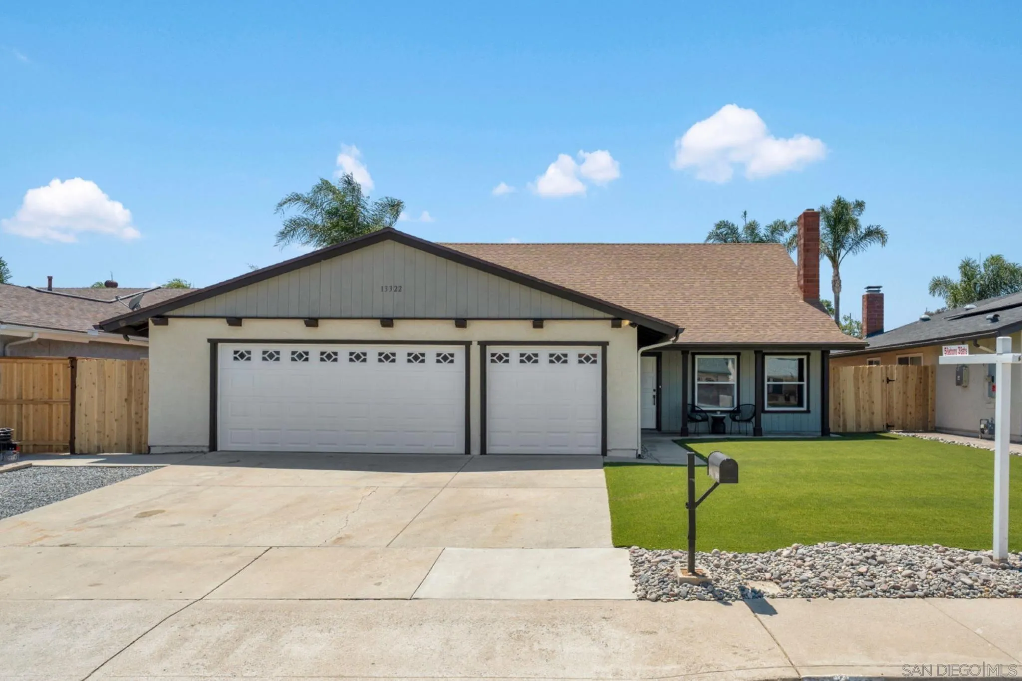 13322 Via Mark Poway, CA 92064 - Photo 2 of 25 a front view of a house with a garden and yard