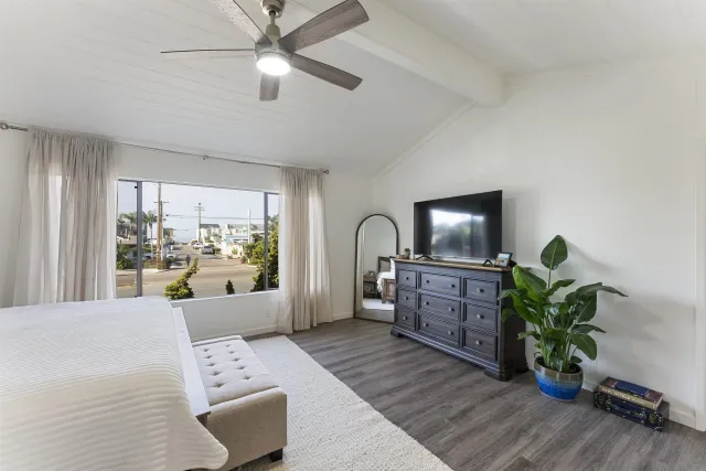 a bedroom with furniture and a potted plant