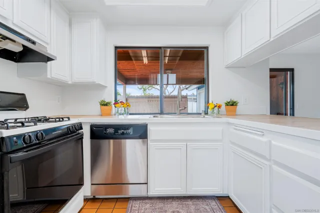a kitchen with stainless steel appliances and white cabinets
