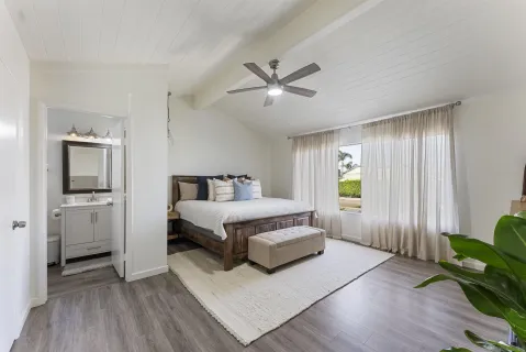 a spacious bedroom with a bed and a window