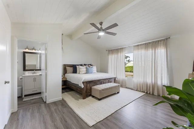 a spacious bedroom with a bed and a window