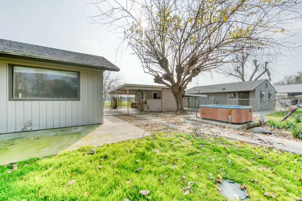 a view of a house with a yard and sitting area
