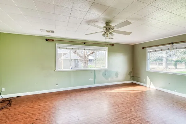 wooden floor in an empty room with a window