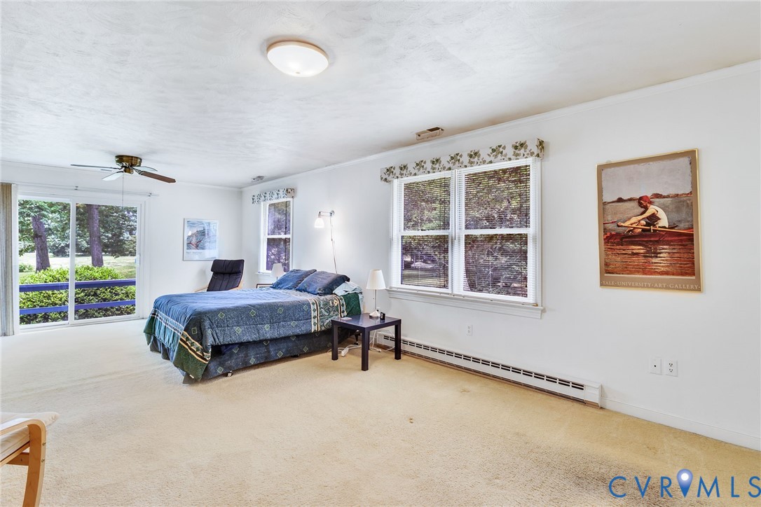 142 Bridge Lane Reedville, VA 22539 - Photo 13 of 56 a spacious bedroom with a bed and a large window