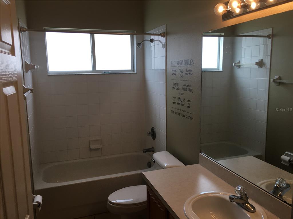 18047 Java Isle Drive Tampa, FL 33647 - Photo 20 of 21 a bathroom with a sink toilet and shower