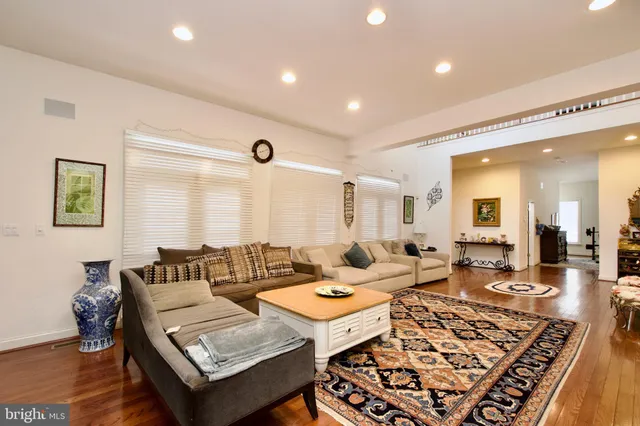 a living room with furniture hard wood floor and a fireplace
