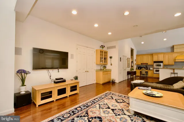 a living room with dining room and wooden floor